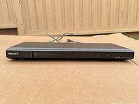 Front view of Sony DVP-NS708H player showing SONY logo and disc tray