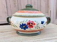 Front view of StoneLite covered casserole showing floral pattern, handles and lid