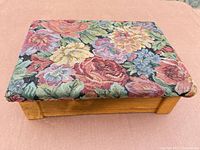 Closed wooden keepsake box with floral tapestry lid