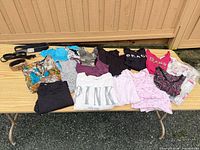 All garments and belts laid on table