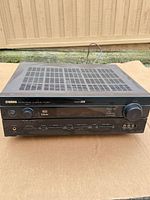 Front and top view of Yamaha HTR-5640 receiver showing overall condition and controls