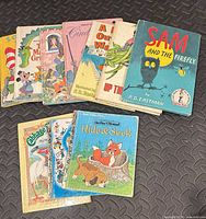 All ten hardcover children’s books fanned out on floor