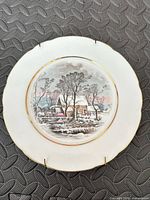 Front view of plate showing winter scene and gold rim