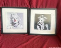 Both framed Marilyn Monroe prints side by side