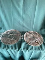 Both clear glass platters side by side showing overall designs and size comparison