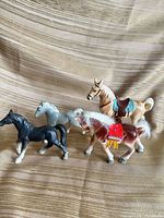 Group shot of four porcelain horse figurines