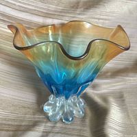 Front view of gradient glass vase showing ruffled rim and clear base