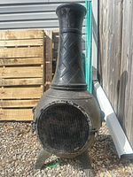 Full view of cast iron chiminea front with mesh screen and legs