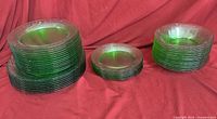 Stacks of green glass dinner, medium and side plates plus bowls