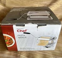 Front of sealed MasterChef Pasta Maker box showing product image and branding