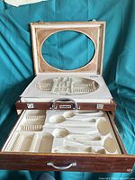 Open box displaying interior molded cutlery tray and lining