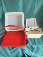 All components: red cake carrier base, off-white cover, cream lunch container with lid and strap
