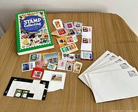 Reference book, loose stamps, envelopes displayed on table