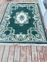 Full rug showing pattern and fringe on wooden deck