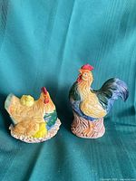 Rooster cookie jar and hen with chicks sugar dish side by side