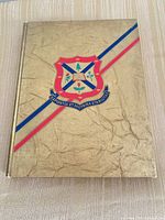 Front cover showing gold textured design and university crest