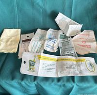 Group view of eight hotel shoe cloths on green surface