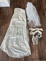 Full view of gown, veil, gloves, shoes, garter