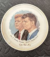 Front view showing portraits and text on plate