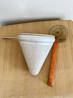 Both strainers side by side for scale and material contrast