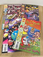 Front covers of all four Ren & Stimpy comic books