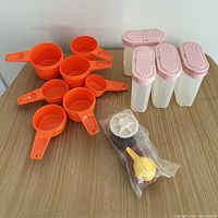 Group shot of entire lot: measuring cups, spice containers, mini accessories in bag
