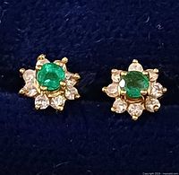 Front view displaying emerald and diamond cluster heads