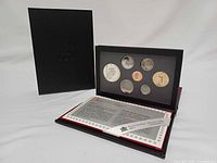 Set displayed open showing coin panel, case, sleeve