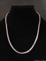 Necklace displayed on bust to show full drape