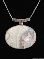 Front view of agate pendant showing stone pattern and silver setting