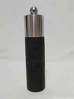Front view showing Haida totem carving and stainless steel top