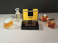 Group image of all five perfume minis with Fendi box and stand