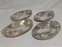 All four Birks Regency silver-plated bread plates, top view