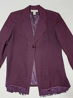 Full view of blazer with scarf peeking below hem