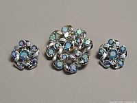 Brooch centered with earrings left and right showing full set