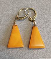 Front view of amber earrings showing triangular shape and gold leverbacks