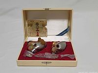 open presentation box showing both duck salts, spoons in plastic, paper insert and Wako tag