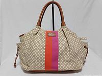 Front view showing pattern, stripe, handles, Kate Spade plaque