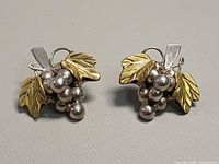 Front view of both grape cluster earrings showing silver beads and brass leaves