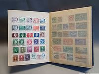 Open album showing two pages of mounted Canadian stamps