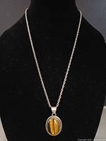 Necklace on black bust showing full length and pendant