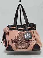 Front view of pink velour Juicy Couture Daydreamer bag showing embroidered crest and overall style.