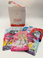 Front view of box and several pouches showing licensed character designs