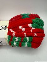 Rolled pack of fuzzy socks red green white