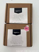 Front view of two sealed AmazonBasics AAAA battery boxes