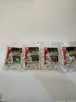 Front view of four branded sealed bags showing Gardner Bender labeling and contents