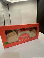 Front view showing sealed kit with visible wood hearts, paint pods and brush