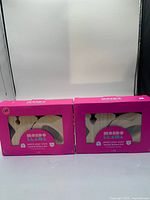 Front view of two boxed kits showing brand and contents through window