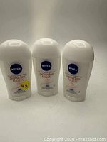 Front view of three Nivea Powder Touch deodorant sticks