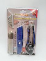 Front of sealed ToolDeal 8-piece utility knife set showing all components